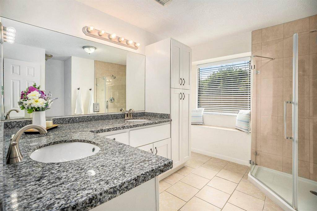 The large window in the master bathroom offers an abundance of natural light along with a large walk in shower.