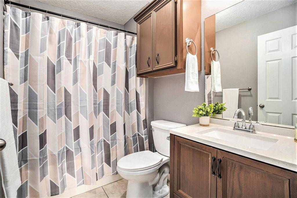 The hallway bathroom is convenient located next to the 2 bedrooms and offers a shower tub combo along with quart counter tops.