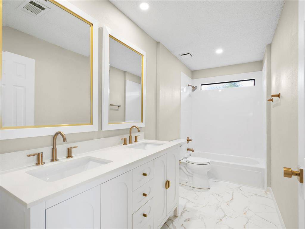 Secondary Bathroom, Shower Tub Combo; All New Tile, Vanity, Mirrors, and Lighting.