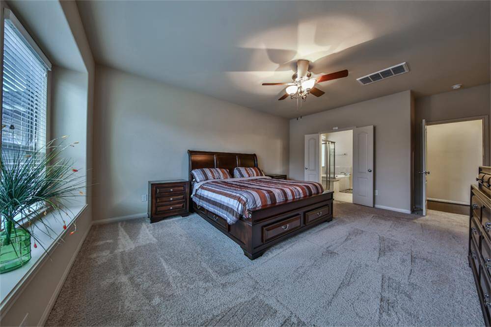 Elegant French doors open to your luxurious en-suite bathroom, creating a grand entrance to your private spa-like retreat.