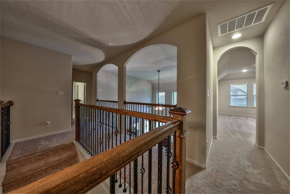 Upstairs offers a stunning view overlooking the grand living area below. In the left wing, you’ll find two charming secondary bedrooms and more to explore!