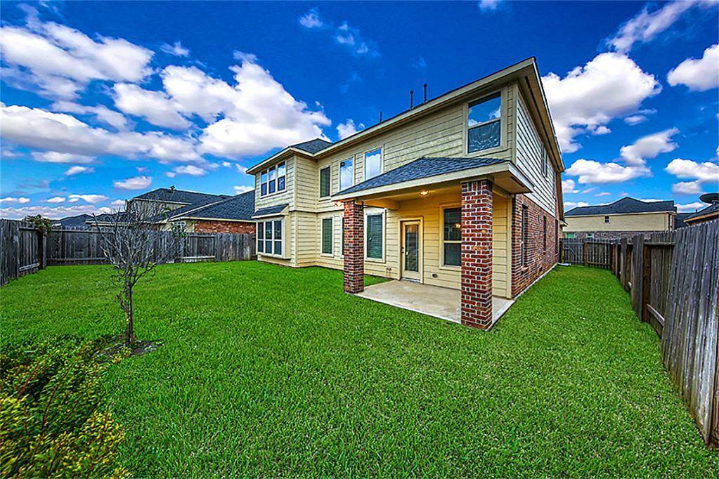 Spacious covered patio features upgraded brick columns, a full insulated glass door, and a gas line—perfectly set up for your outdoor grill and entertaining year-round!