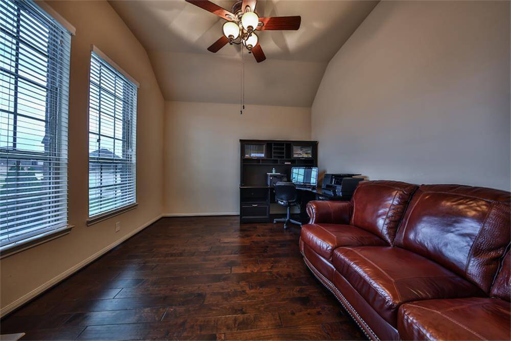 French glass panel doors open to a spacious study with large plank wood floors, soaring ceilings, and a custom ceiling fan—ideal for a stylish home office! Be sure to check the listing documents and virtual tour for more details!