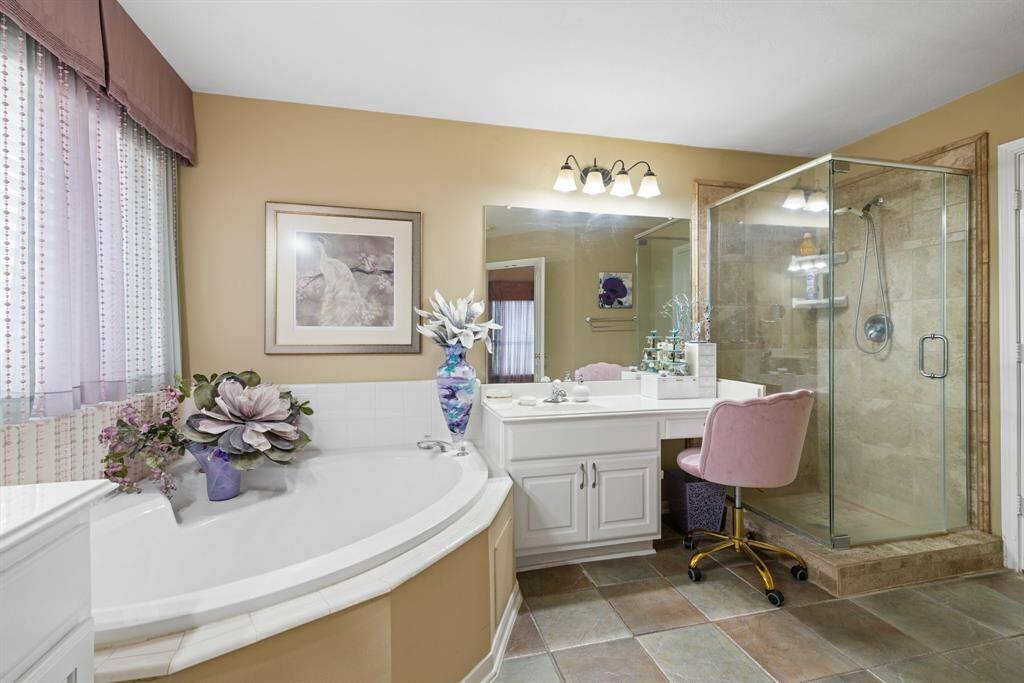 Glam counter, large mirrors and walk in shower.
