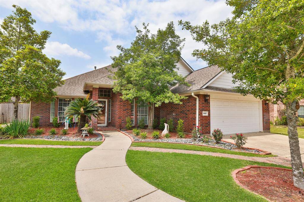 Elegant walkway and exquisite landscaping lead you to the home's front entry.