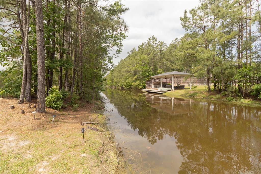 At the end of this HUGE backyard you have lake access! Drop in your boat, kayak or your fishing poles. Plenty of room to build your own dock!