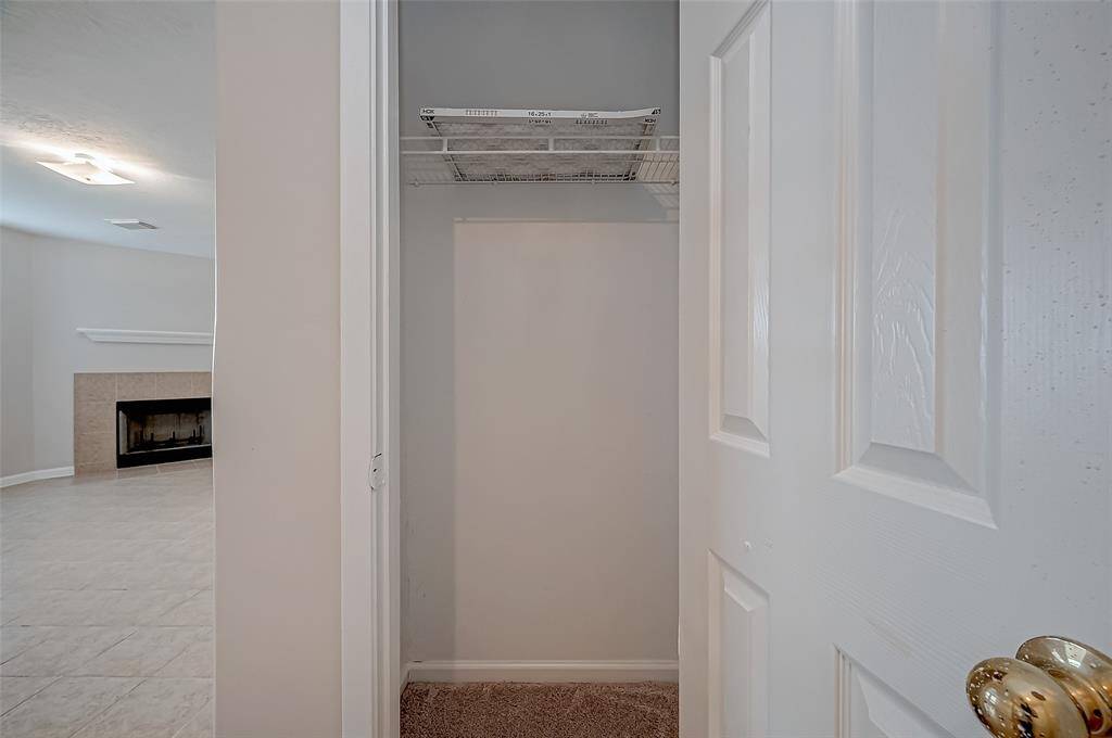 Positioned just opposite the front door, a dedicated storage space features a built-in rack, providing a convenient spot for coats, shoes, or everyday essentials.
