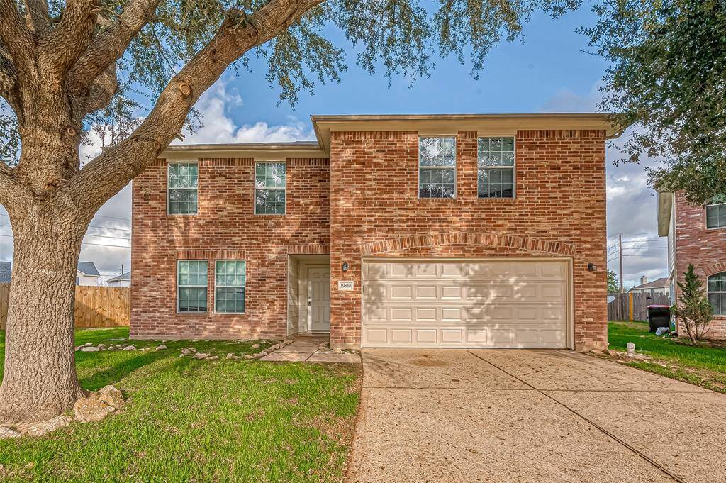 The lovely brick exterior gives this home a timeless appeal, complemented by a neatly maintained front lawn. A mature tree adds shade and character to the property.
