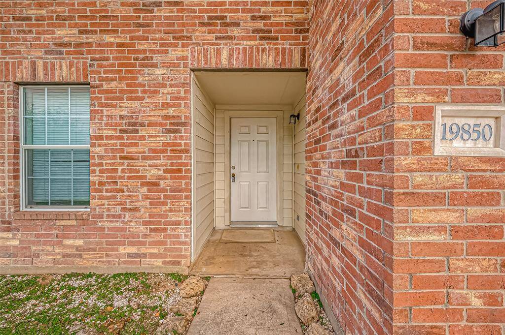 A closer view of the front entry reveals a compact covered space, creating a sheltered area before stepping inside.