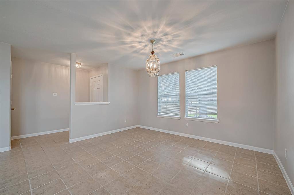 The entryway opens directly into the expansive living room, where natural light fills the space, highlighting its open layout.