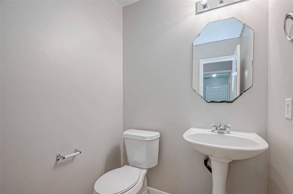 A simple yet functional half bathroom is conveniently located, providing easy access for guests.