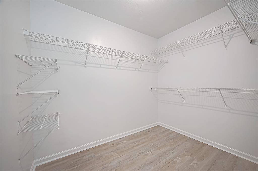 The full entry closet provides ample space for storage, featuring built-in racks to maximize organization.