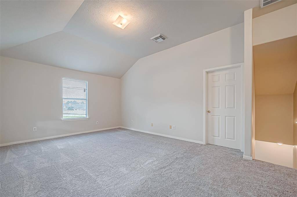 The upstairs landing offers a versatile space, with sloping ceilings adding a cozy feel. Large windows ensure plenty of natural light.