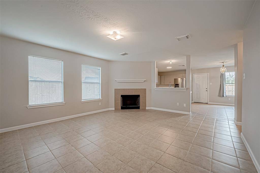 The open layout connects the living room to the kitchen and dining area through a wide, open wall allowing for easy flow between spaces.
