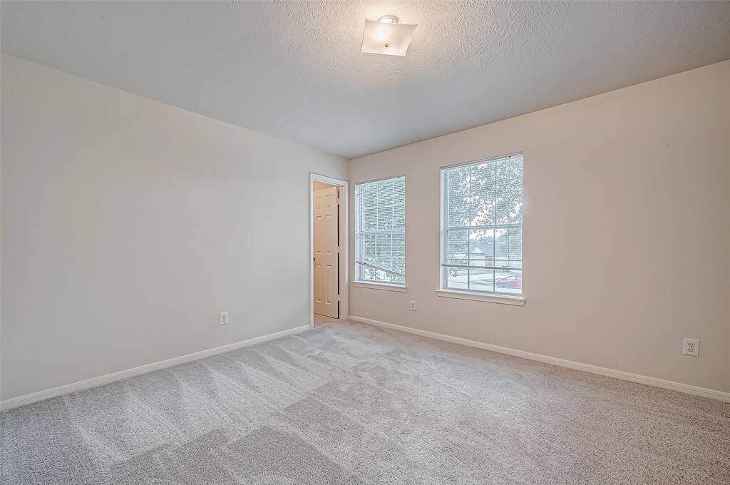This upstairs bedroom is carpeted for comfort, with a spacious full entry closet providing ample storage.