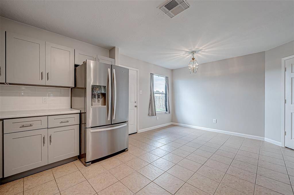 Well-lit and airy, the kitchen overlooks the living room, allowing for easy interaction while preparing meals.