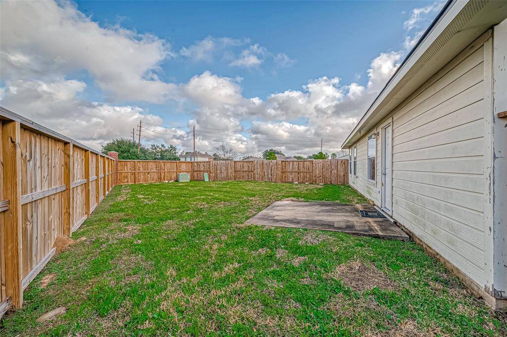 A small patio area extends from the home, providing a spot for outdoor seating or a barbecue setup.