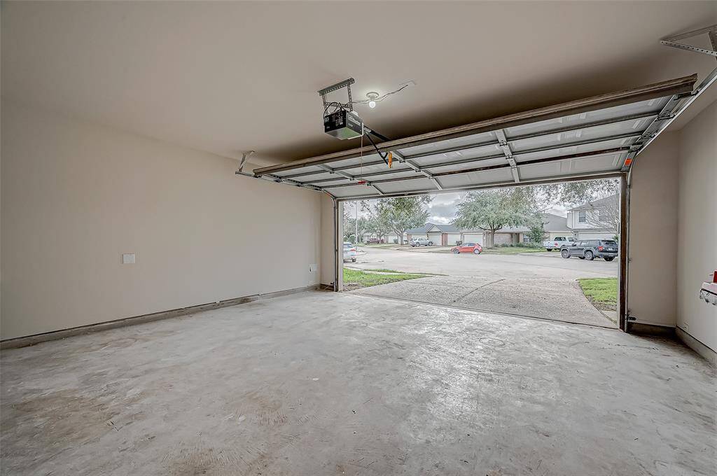 The attached garage offers an expansive indoor space, ideal for parking and additional storage needs.