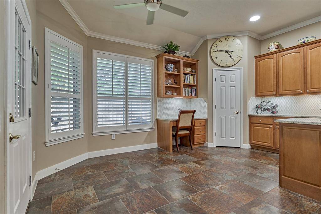 The breakfast area adjacent to the kitchen features a built-in desk and a walk-in pantry.