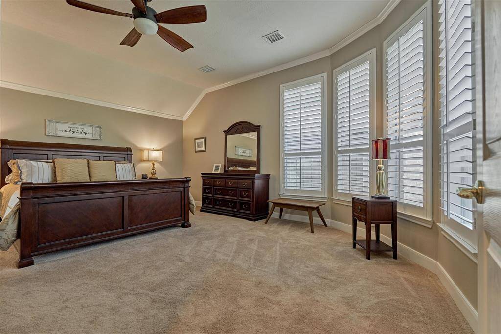 The main suite features a wall of windows and a bright sitting area.
