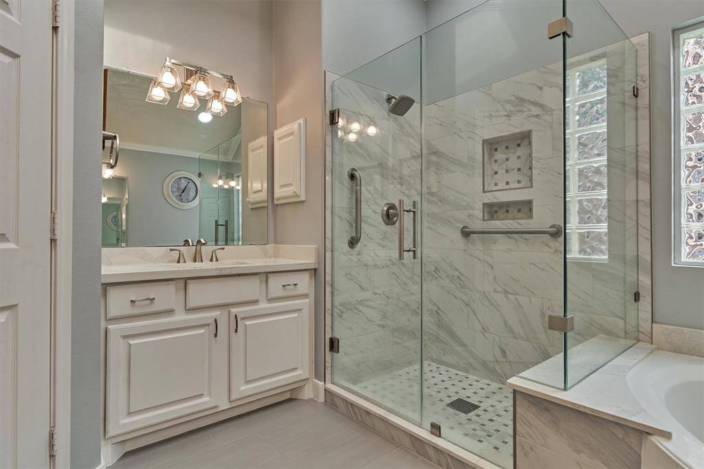 The shower is spacious and features a generously sized bench.