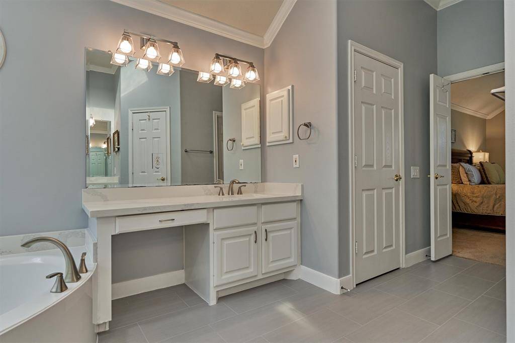 This section of the main bathroom has a vanity space.
