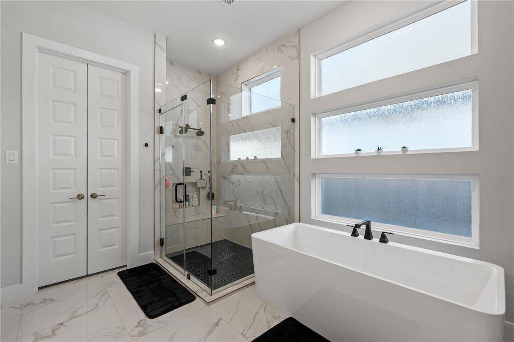 Marble flooring, soaking tub and large walkin shower
