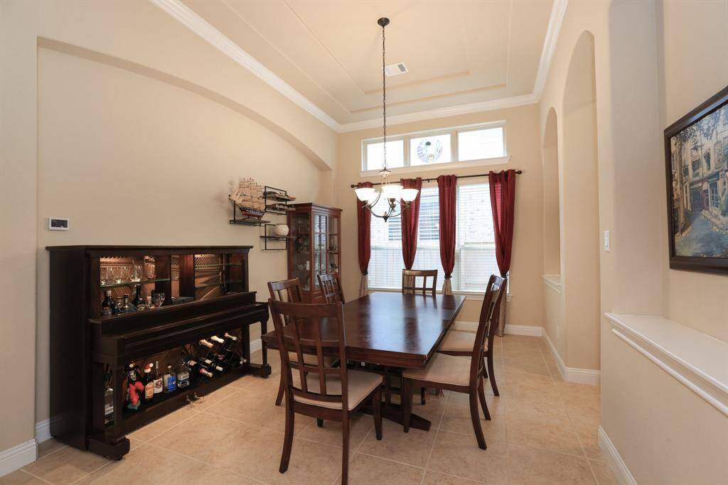 Formal dining with kitchen access and double recessed niches for pictures and display decor.