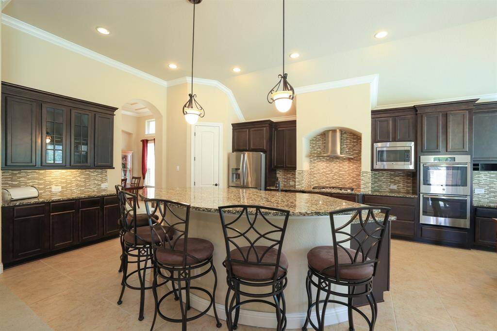 Easily fit 6 bar stools at the island. Double ovens and microwave