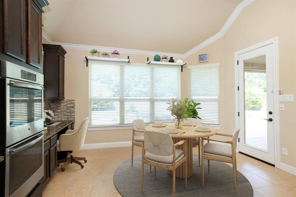 Full backyard views and exterior door to covered patio