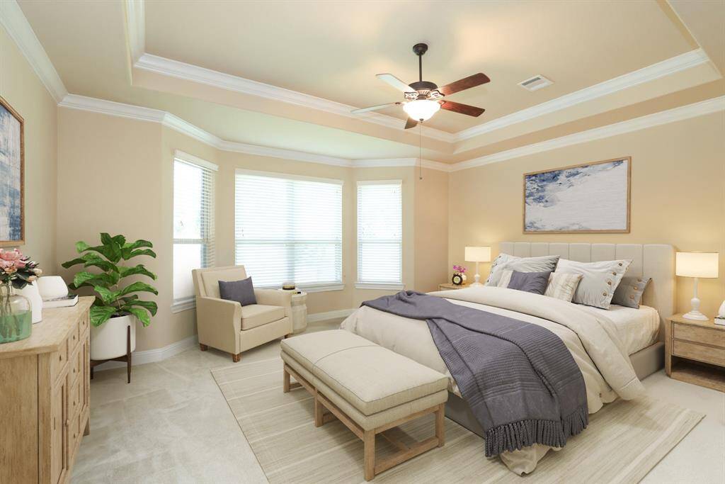 Primary bedroom with inverted ceilings and crowm molding. Carpeted floors. Neutral paint. TANKLESS WATER HEATER.