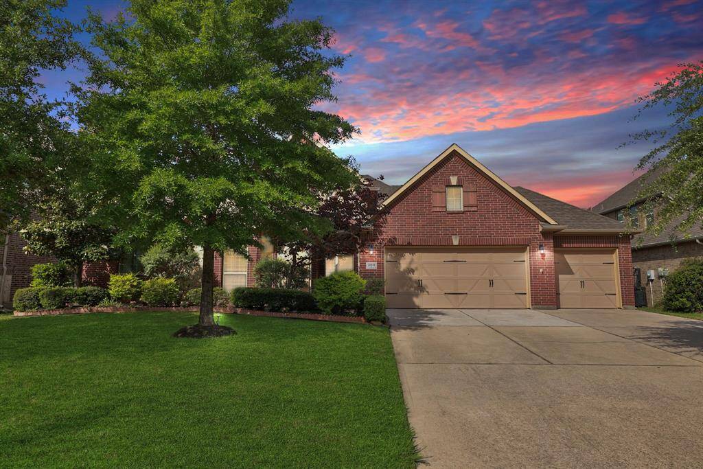 Elongated driveway to 3 car front load garage with side door to backyard making maintenance days easy.