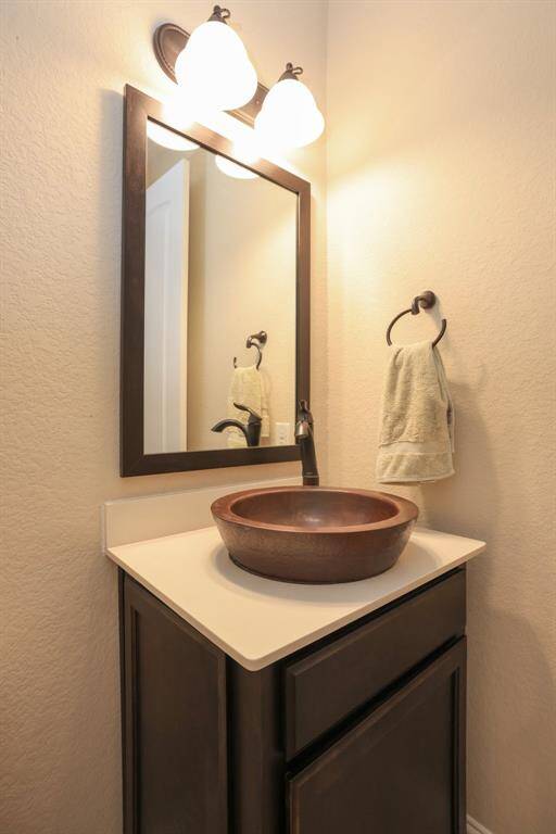 Powder bath with copper sink and oil rubbed bronze faucet and towel rack