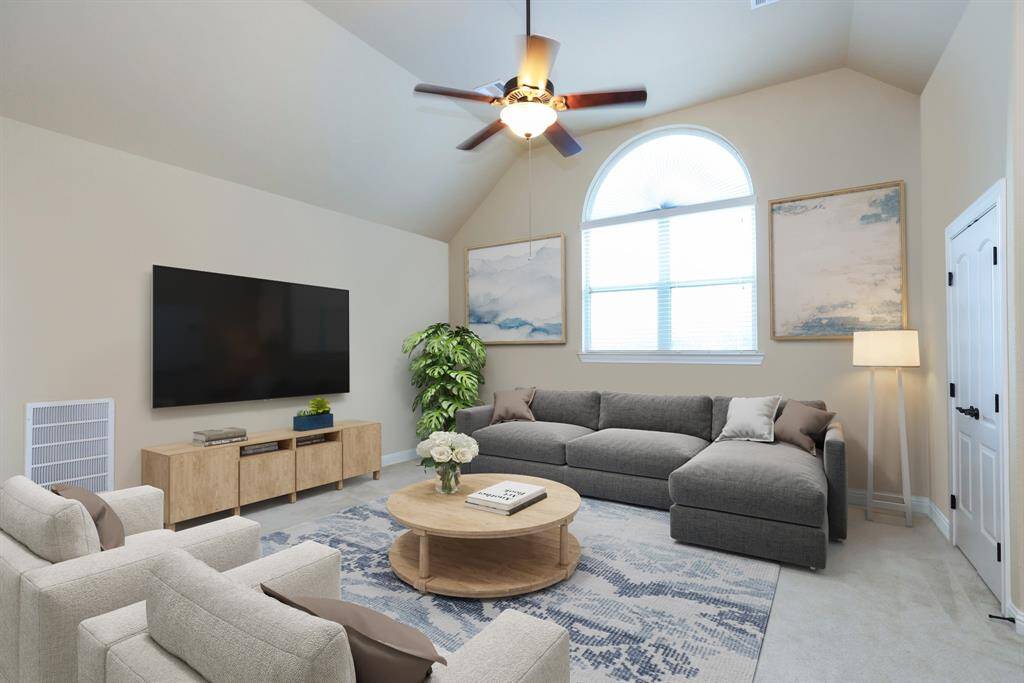 Game room with storrage closet. Carpeted floors. Arched windows.