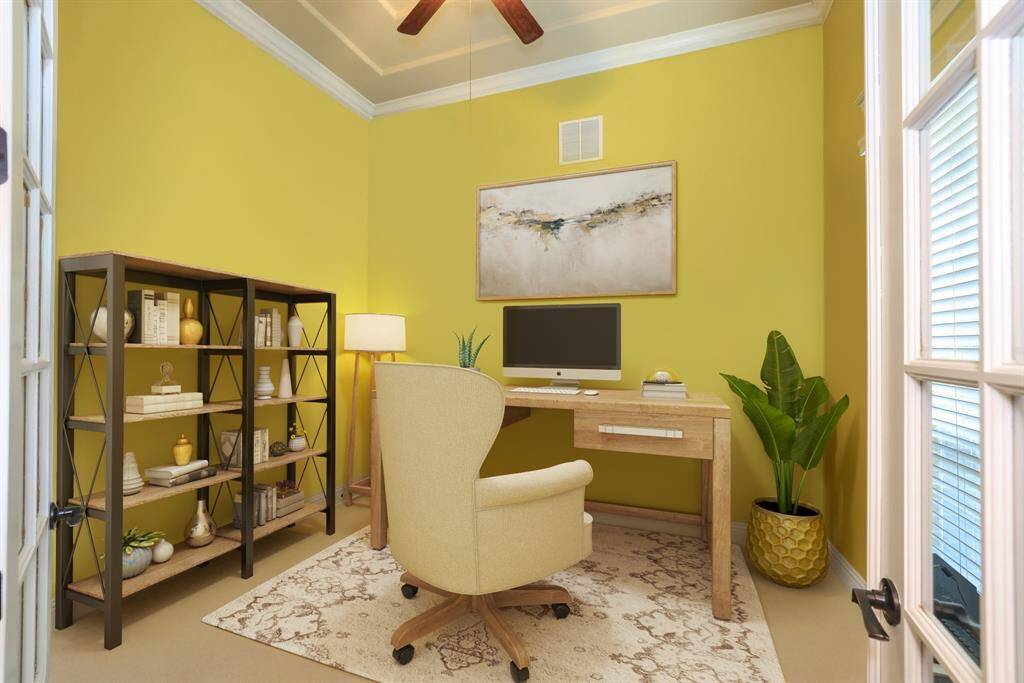 Study with double glass doors, tall ceilings crown molding and fan with light kit. Beautiful windows to courtyard