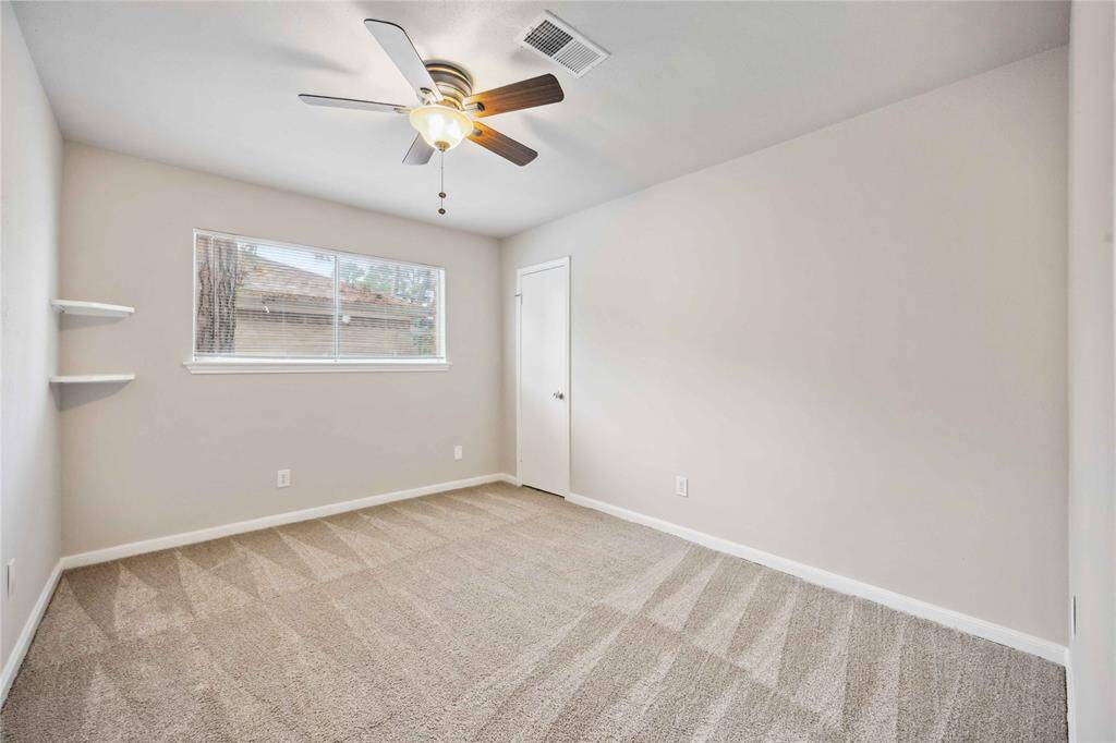 2nd bedroom with built-in shelving.