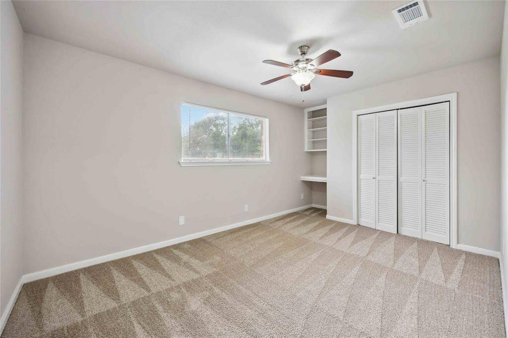 3rd bedroom with a built-in desk and shelving.