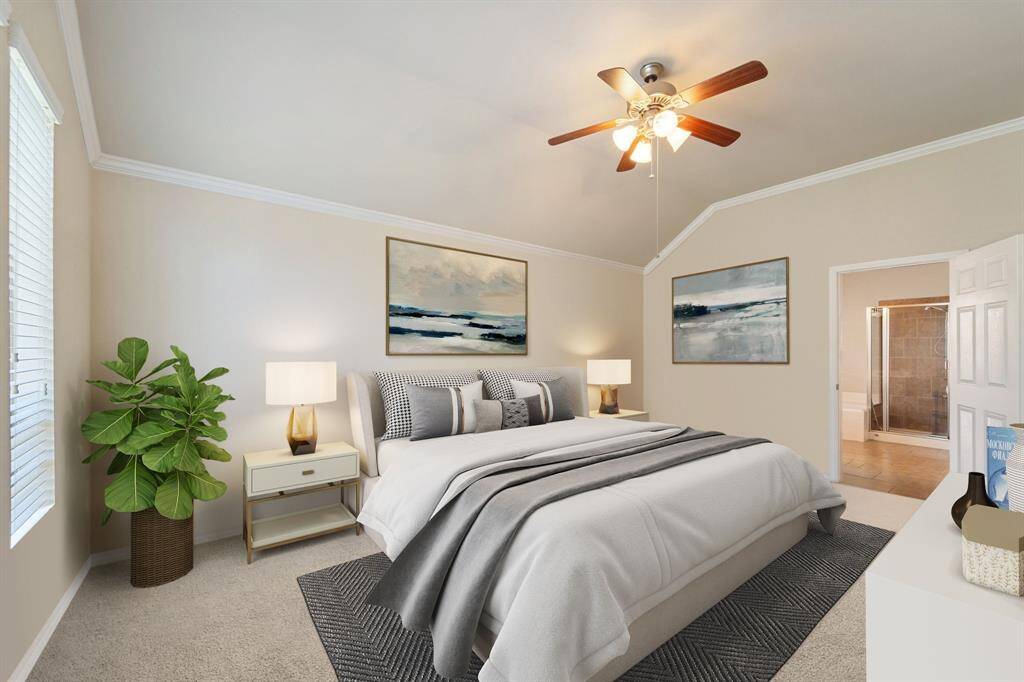 This spacious primary bedroom boasts plush carpet, elegant crown molding, a ceiling fan for year-round comfort, and multiple windows with privacy blinds that invite natural light while maintaining your retreat’s serenity. *Virtually Staged*