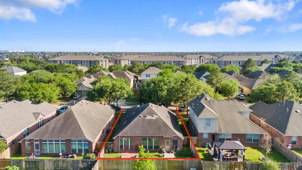 Take in the stunning aerial view of this beautiful home, offering a glimpse of the surrounding neighborhood, showcasing its charm and convenient location.