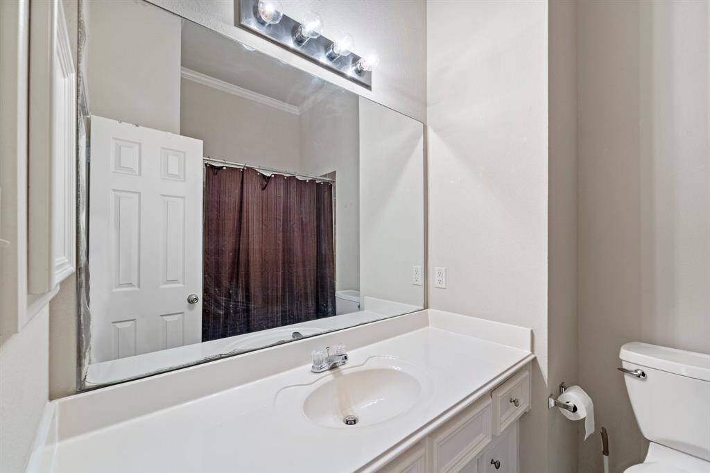 This bathroom offers a clean and functional layout with a shower/tub combo, a sleek white vanity with ample counter space, and a toilet—perfect for everyday convenience.