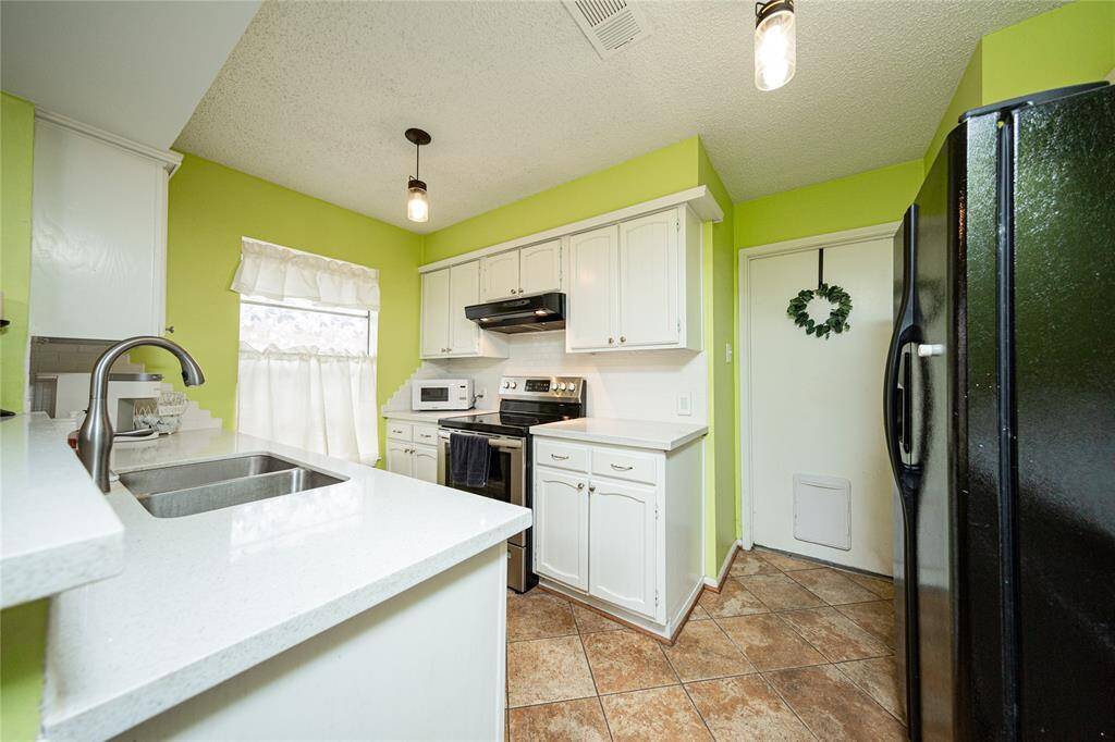 The kitchen has been updated with granite countertops, backsplash and painted cabinets.