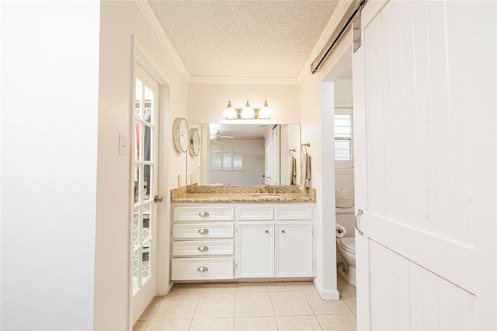 The vanity in the primary bathroom is separated from the shower area.