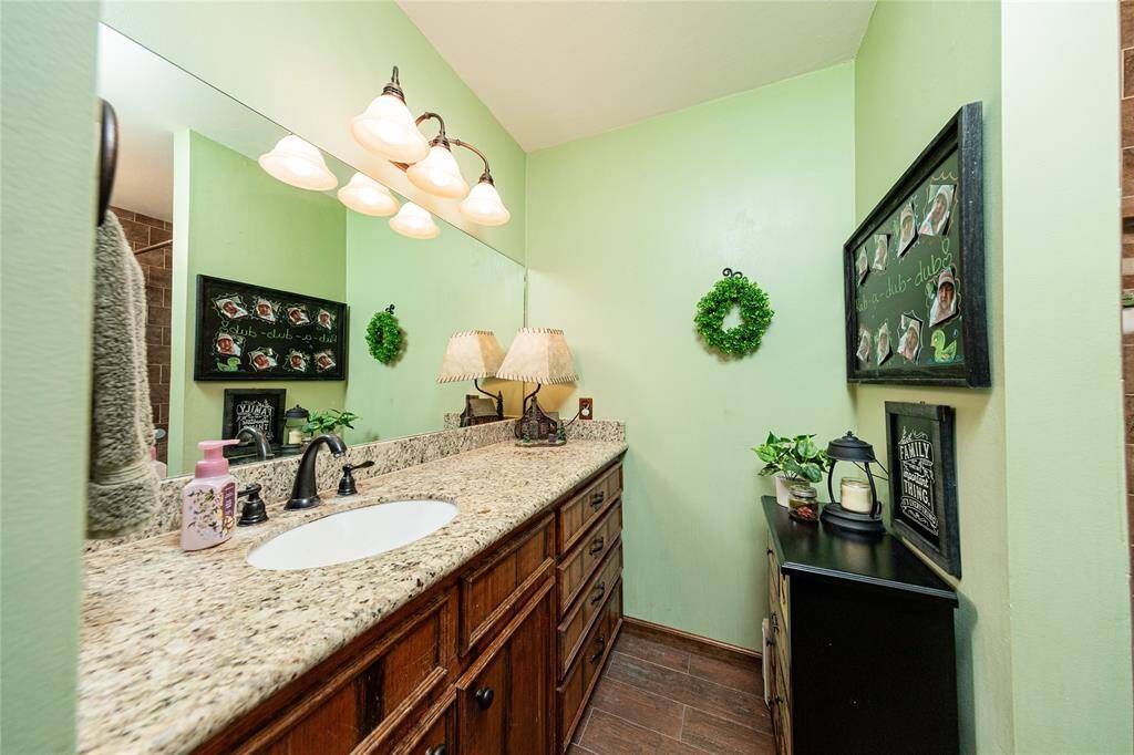 Granite counters, new tile work and updated light fixtures have been installed in the secondary bathroom.
