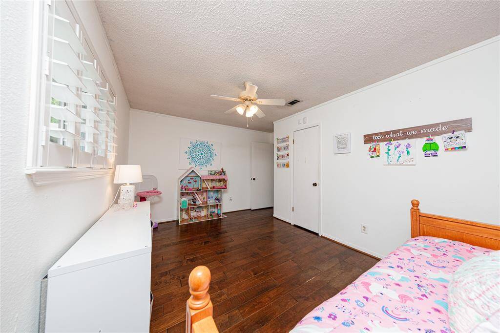 This room has a large closet and plantation shutters as well.