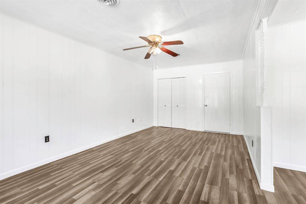 open living room area doors lead to utility rooms and kitchen.