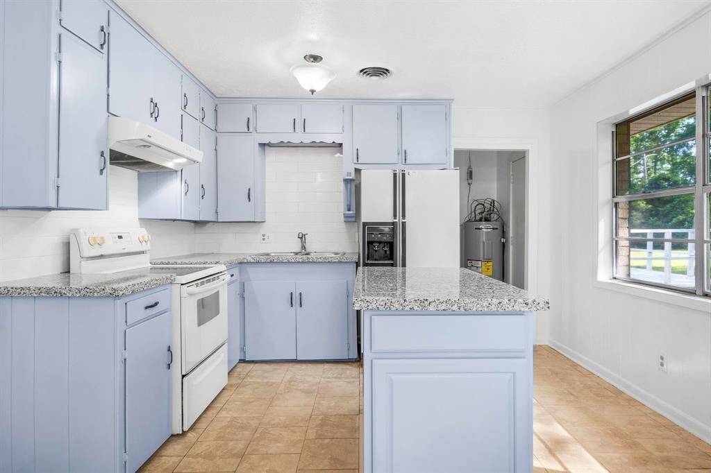 Freshly painted cabinets with new granite counter tops.  Refrigator and oven range convey with the property.