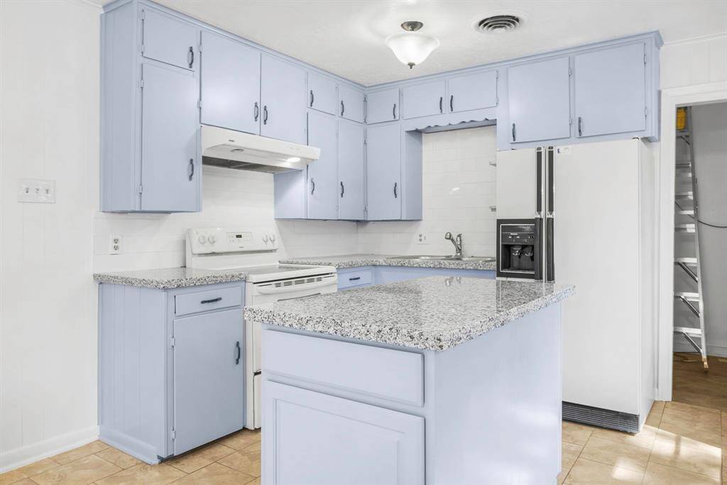 plenty of cabinets for storage and center island .