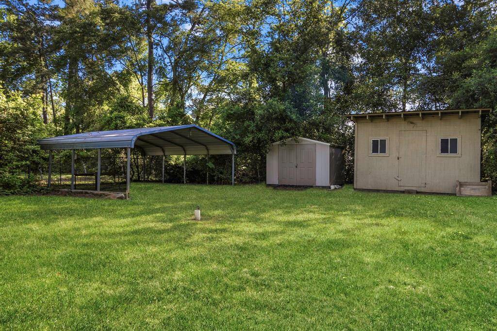 back of property with extra storage units and workshop that convey with the property!