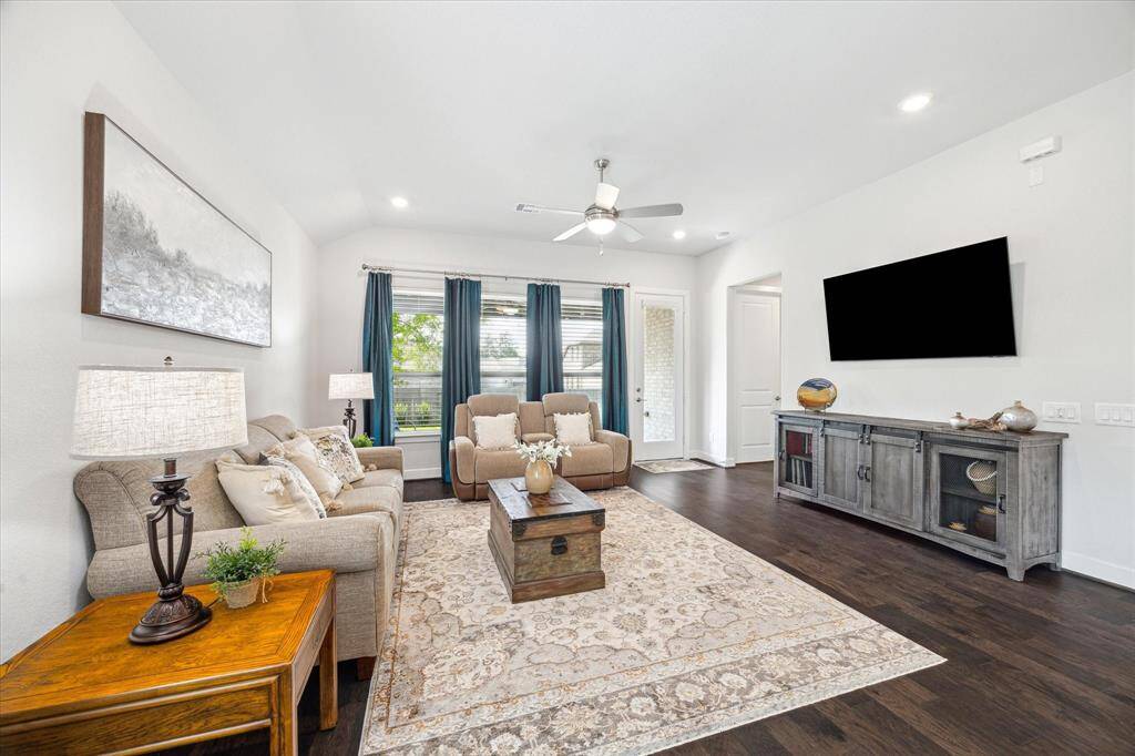Spacious Family room that will accommodate your furniture needs.  Three large windows looking out onto the back porch and landscaped backyard.