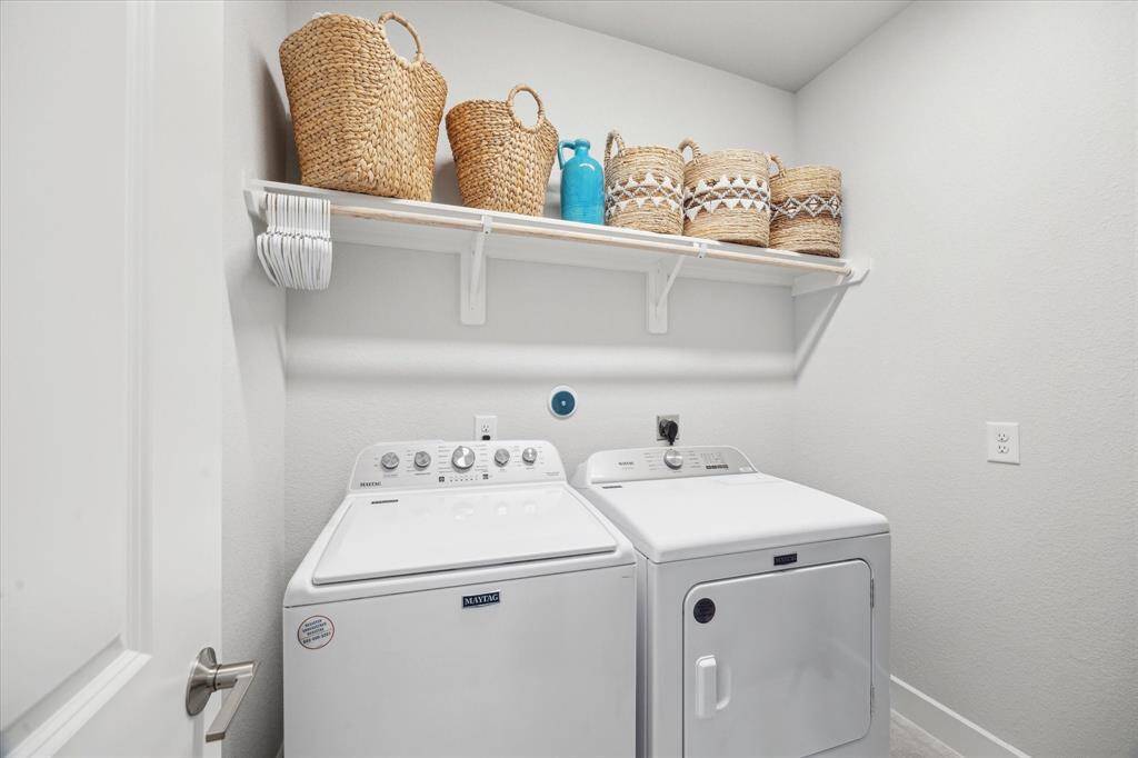 Laundry room with ample space and room for additional cabinets on right side.